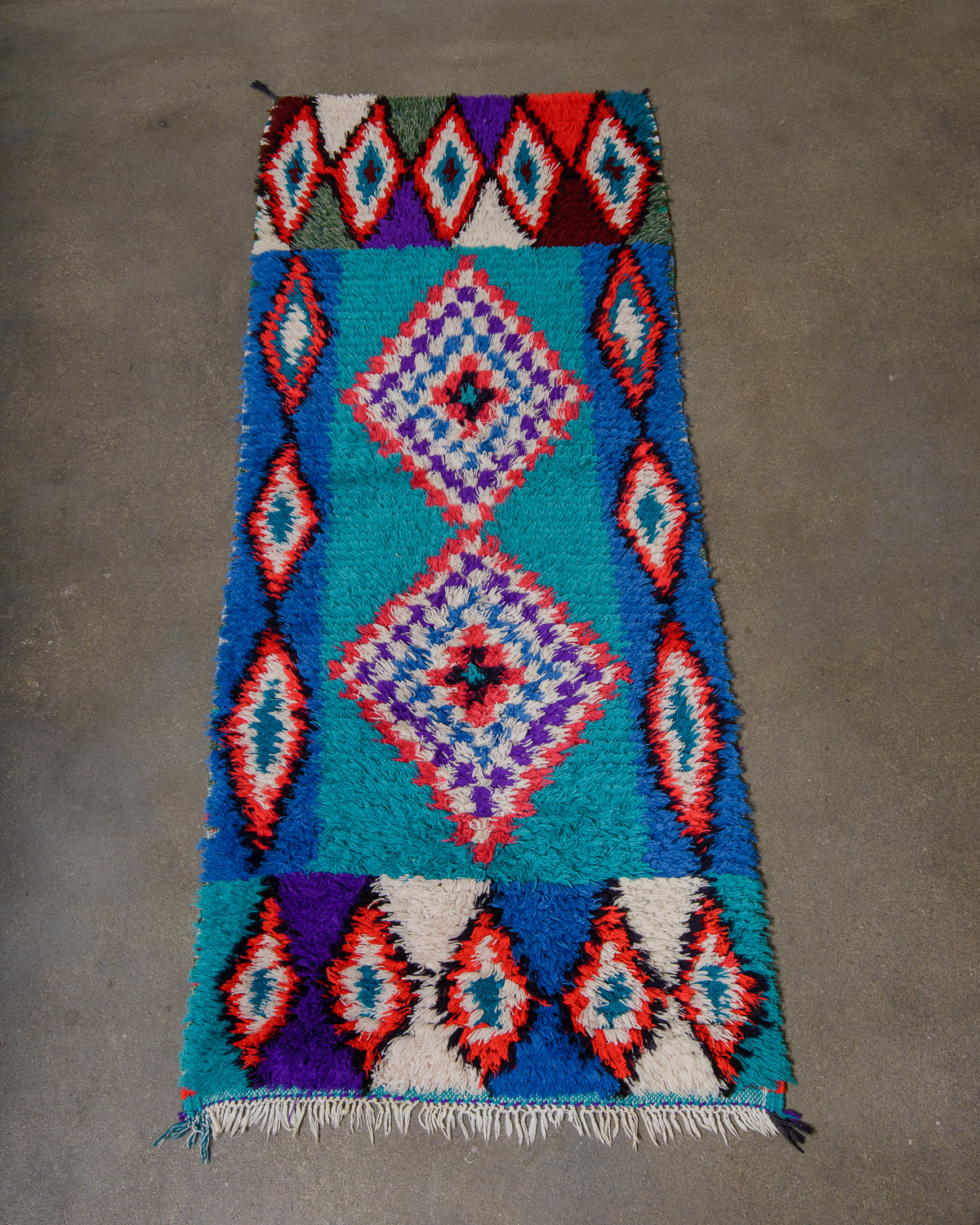 Colourful geometric patterned rug on a grey floor